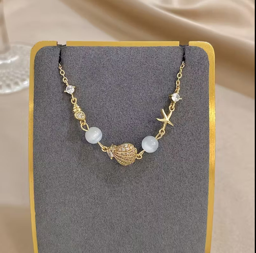 Gold-Plated Seashell & Starfish Charm Bracelet with Zirconia Accents
